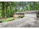 Beautiful brick home with an attached garage and a long driveway, surrounded by lush trees at 505 Samaritan Dr, Cumming, GA 30040