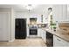 Well-equipped kitchen boasts white cabinetry, stainless steel appliances, and granite countertops with a stylish backsplash at 505 Samaritan Dr, Cumming, GA 30040