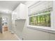 Laundry room featuring ample storage cabinets and a window that overlooks a wooded area at 505 Samaritan Dr, Cumming, GA 30040