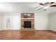 Spacious living room with hardwood floors, a brick fireplace, and lots of natural light at 505 Samaritan Dr, Cumming, GA 30040