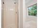 Bright bathroom features a shower and a window to bring natural light at 5137 Allison Way, Sugar Hill, GA 30518