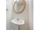 Pedestal sink and gold framed mirror add a touch of elegance to the bathroom at 5137 Allison Way, Sugar Hill, GA 30518