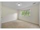 Neutral bedroom features a window that offers natural light and outdoor views at 5137 Allison Way, Sugar Hill, GA 30518
