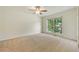 Spacious bedroom features neutral carpet, a ceiling fan, and a large window at 5137 Allison Way, Sugar Hill, GA 30518