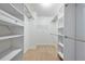 Walk-in closet with built-in shelving and racks for optimal storage solutions at 5137 Allison Way, Sugar Hill, GA 30518