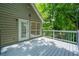 Beautiful deck with serene wooded views and string lights perfect for outdoor entertaining at 5137 Allison Way, Sugar Hill, GA 30518