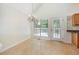 Bright dining area adjacent to the kitchen with tile floors and glass doors to backyard deck at 5137 Allison Way, Sugar Hill, GA 30518