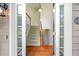 Inviting foyer with hardwood floors and stairs leading to the upper level of the home at 5137 Allison Way, Sugar Hill, GA 30518