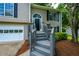 The front entrance has gray painted stairs, door, and siding, plus some attractive shrubbery at 5137 Allison Way, Sugar Hill, GA 30518