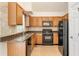 Well-lit kitchen features granite countertops, tile backsplash and wooden cabinets at 5137 Allison Way, Sugar Hill, GA 30518