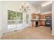 Well-lit kitchen/dining area features tile floors, granite counters, black appliances, and deck access at 5137 Allison Way, Sugar Hill, GA 30518