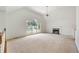 Spacious living room with vaulted ceilings, a fireplace, large windows and neutral carpet at 5137 Allison Way, Sugar Hill, GA 30518