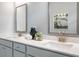 Bathroom with double vanity, white countertops, and framed mirrors at 5415 Trescott Path, Cumming, GA 30028