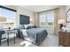 Comfortable bedroom with a desk, large windows, and a neutral color palette at 5415 Trescott Path, Cumming, GA 30028