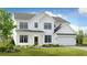 Beautiful new construction two-story home with white siding, black framed windows, and well-manicured front yard at 5415 Trescott Path, Cumming, GA 30028