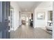 Bright, naturally lit foyer featuring luxury vinyl plank flooring and views of living spaces at 5415 Trescott Path, Cumming, GA 30028