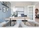 Well-designed home office with contemporary decor, ample lighting, and cozy seating arrangements at 5415 Trescott Path, Cumming, GA 30028