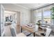 Bright home office featuring hardwood flooring, glass door and an office view to the dining area at 5415 Trescott Path, Cumming, GA 30028