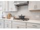 Modern kitchen features white cabinets, herringbone tile backsplash, and stainless steel range hood at 5415 Trescott Path, Cumming, GA 30028