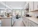 Open concept kitchen with island, stainless hood, modern lighting, and ample counter space at 5415 Trescott Path, Cumming, GA 30028