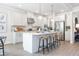 Modern kitchen with island, stainless steel appliances, pendant lighting, and ample counter space at 5415 Trescott Path, Cumming, GA 30028