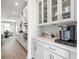 Bright, white kitchen features sleek cabinetry, stainless steel appliances, and a convenient coffee bar area at 5415 Trescott Path, Cumming, GA 30028