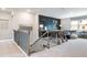 A loft area with stairs, foosball table, sectional seating and a black rock and roll accent wall at 5415 Trescott Path, Cumming, GA 30028