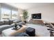 A spacious loft featuring a sectional couch, large windows, entertainment center and foosball table at 5415 Trescott Path, Cumming, GA 30028