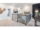 View of the loft area featuring a foosball table, black accent wall, and staircase at 5415 Trescott Path, Cumming, GA 30028