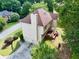 Aerial back view of home with deck, overlooking well-manicured lawn and mature trees at 1350 Rivershyre Pkwy, Lawrenceville, GA 30043