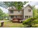 Back of home featuring a deck, spacious backyard, and mature trees at 1350 Rivershyre Pkwy, Lawrenceville, GA 30043