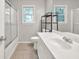 Neutral bathroom features a shower-tub combination and a large vanity with a framed mirror at 1350 Rivershyre Pkwy, Lawrenceville, GA 30043
