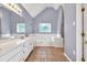 Spacious bathroom with double vanity, tub, tile floor, and a decorative window for natural light at 1350 Rivershyre Pkwy, Lawrenceville, GA 30043