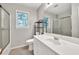 Neutral bathroom features a shower-tub combination and a large vanity with a framed mirror at 1350 Rivershyre Pkwy, Lawrenceville, GA 30043