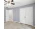 Neutral bedroom with a ceiling fan and double closets for ample storage space at 1350 Rivershyre Pkwy, Lawrenceville, GA 30043