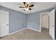Comfortable carpeted bedroom featuring neutral walls and a large window to let in natural light at 1350 Rivershyre Pkwy, Lawrenceville, GA 30043