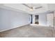 Large bedroom with doorway leading to a bathroom, neutral carpet, and a ceiling fan at 1350 Rivershyre Pkwy, Lawrenceville, GA 30043