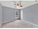A light-filled bedroom features neutral walls, carpet, and a ceiling fan with integrated lighting at 1350 Rivershyre Pkwy, Lawrenceville, GA 30043