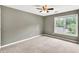Comfortable carpeted bedroom featuring neutral walls and a large window to let in natural light at 1350 Rivershyre Pkwy, Lawrenceville, GA 30043