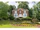 Charming two-story brick home with a landscaped front yard and wooden retaining wall at 1350 Rivershyre Pkwy, Lawrenceville, GA 30043