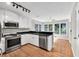 Updated kitchen with white cabinets, stainless steel appliances, and hardwood floors at 1350 Rivershyre Pkwy, Lawrenceville, GA 30043