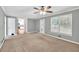 Spacious living room featuring carpet flooring and large windows overlooking the backyard at 1350 Rivershyre Pkwy, Lawrenceville, GA 30043