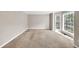 Neutral carpeted living room with large bay windows and natural light at 1350 Rivershyre Pkwy, Lawrenceville, GA 30043