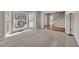 Spacious living room with large windows and neutral carpet and paint at 1350 Rivershyre Pkwy, Lawrenceville, GA 30043