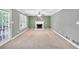 Spacious living room with fireplace and carpet flooring, complemented by neutral wall colors at 1350 Rivershyre Pkwy, Lawrenceville, GA 30043