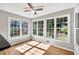 Sunroom with hardwood floors and large windows providing ample natural light and backyard views at 1350 Rivershyre Pkwy, Lawrenceville, GA 30043
