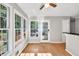 Sunroom featuring hardwood floors, ample natural light, and a view of the backyard deck at 1350 Rivershyre Pkwy, Lawrenceville, GA 30043