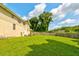 Large, grassy backyard with a table and umbrella set, surrounded by a wooden fence and mature trees at 1848 Winthrop Se Dr, Atlanta, GA 30316