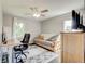 This bedroom functions as a flex space with a desk, futon, and mounted television at 1848 Winthrop Se Dr, Atlanta, GA 30316