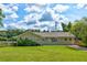 Charming one-story brick home featuring a well-manicured lawn and lush greenery on a partially cloudy day at 1848 Winthrop Se Dr, Atlanta, GA 30316